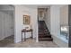 Elegant entryway with dark wood staircase and tile flooring at 7275 N Scottsdale Rd # 1001, Paradise Valley, AZ 85253