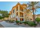 Luxury 3-story building with Spanish-style architecture, palm trees, and manicured landscaping at 7275 N Scottsdale Rd # 1001, Paradise Valley, AZ 85253