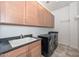 Laundry room with washer, dryer, and ample cabinet space at 7275 N Scottsdale Rd # 1001, Paradise Valley, AZ 85253