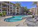 Relaxing kidney-shaped pool with lounge chairs and spa at 7275 N Scottsdale Rd # 1001, Paradise Valley, AZ 85253