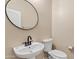 Small bathroom with pedestal sink and toilet at 7846 W Adam Ave, Peoria, AZ 85382