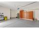 Garage interior with built-in cabinets and flooring at 7846 W Adam Ave, Peoria, AZ 85382