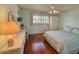 Bedroom with hardwood floors and white wicker furniture at 8013 N Via Palma St, Scottsdale, AZ 85258