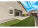 Artificial turf backyard with patio and partial view of neighbor's home at 815 S 151St Ln, Goodyear, AZ 85338