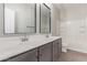 Bathroom with double vanity, tub and gray cabinets at 815 S 151St Ln, Goodyear, AZ 85338