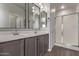 Double vanity bathroom with modern gray cabinets and shower at 815 S 151St Ln, Goodyear, AZ 85338