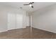 Bedroom with ceiling fan, hardwood floors and double door closet at 815 S 151St Ln, Goodyear, AZ 85338