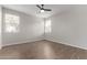 Well-lit bedroom with ceiling fan and hardwood floors at 815 S 151St Ln, Goodyear, AZ 85338