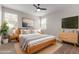 Well-lit bedroom featuring modern decor, sleek furnishings, and contemporary artwork at 815 S 151St Ln, Goodyear, AZ 85338