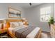 Light-filled bedroom with modern decor, natural wood furniture, and comfortable bedding at 815 S 151St Ln, Goodyear, AZ 85338