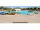 Spacious community pool with lounge chairs and desert landscaping at 815 S 151St Ln, Goodyear, AZ 85338