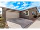 House exterior featuring a beige facade and a two-car garage at 815 S 151St Ln, Goodyear, AZ 85338