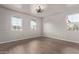 Bright living room featuring hardwood floors and elegant chandelier at 815 S 151St Ln, Goodyear, AZ 85338