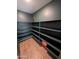 Spacious pantry with custom shelving provides ample storage at 815 S 151St Ln, Goodyear, AZ 85338