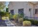 Landscaped backyard with walkway and rose bushes at 8220 N 15Th Ave, Phoenix, AZ 85021