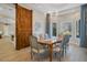 Elegant dining room features a large wood table, chandelier, and barn door at 8220 N 15Th Ave, Phoenix, AZ 85021