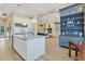 Bright kitchen with island, white cabinetry, and open to living space at 8220 N 15Th Ave, Phoenix, AZ 85021