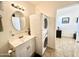 Bright bathroom with vanity, stacked washer/dryer, and mirror at 840 S Aquamarine Dr, Apache Junction, AZ 85119