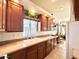 View of kitchen with wood cabinets, a double sink, and a window at 840 S Aquamarine Dr, Apache Junction, AZ 85119