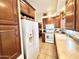 Kitchen features wood cabinets, white appliances, and a spacious layout at 840 S Aquamarine Dr, Apache Junction, AZ 85119