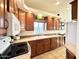 Bright kitchen with wood cabinets, white appliances, and a double sink at 840 S Aquamarine Dr, Apache Junction, AZ 85119