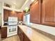 Bright kitchen with wood cabinets, white appliances, and a double sink at 840 S Aquamarine Dr, Apache Junction, AZ 85119