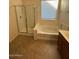 Bathroom features a soaking tub, shower, and tile flooring at 8498 W Maya Dr, Peoria, AZ 85383