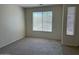 Empty carpeted bedroom with two windows at 8498 W Maya Dr, Peoria, AZ 85383