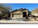 One-story house with tan exterior, two-car garage, and desert landscaping at 8498 W Maya Dr, Peoria, AZ 85383