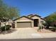 A single-story home featuring a two-car garage and desert landscaping against a clear blue sky at 8498 W Maya Dr, Peoria, AZ 85383
