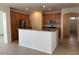 Open kitchen showcases wood cabinetry, stainless steel appliances, and a counter island for seating at 8498 W Maya Dr, Peoria, AZ 85383