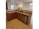 Kitchen with stainless steel dishwasher and corner sink at 8498 W Maya Dr, Peoria, AZ 85383