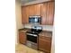 Stainless steel appliances and wood cabinets in this kitchen at 8498 W Maya Dr, Peoria, AZ 85383