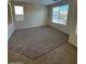 Living room with neutral carpet and large windows at 8498 W Maya Dr, Peoria, AZ 85383