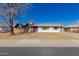 Charming ranch home features a brick and white exterior, landscaping, and a purple door at 936 E 8Th Pl, Mesa, AZ 85203