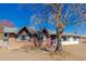 Brick and white ranch house with a purple front door and a mature tree in front at 936 E 8Th Pl, Mesa, AZ 85203