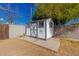 Detached storage shed in backyard with unique sun design at 936 E 8Th Pl, Mesa, AZ 85203