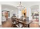 Bright dining room with hardwood floors, a large table, and access to the living room at 10756 E Ludlow Dr, Scottsdale, AZ 85255