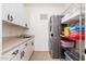 Laundry room with washer, dryer, and ample storage at 10756 E Ludlow Dr, Scottsdale, AZ 85255