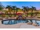 Tranquil pool and spa with waterfall feature and palm trees at 10756 E Ludlow Dr, Scottsdale, AZ 85255