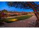 Landscaped putting green with lighting, perfect for evening use at 10756 E Ludlow Dr, Scottsdale, AZ 85255