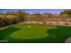 Private putting green in backyard, ideal for golf enthusiasts at 10756 E Ludlow Dr, Scottsdale, AZ 85255