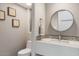 Modern bathroom with mosaic tile and round mirror at 10758 E Tamarisk Way, Scottsdale, AZ 85262