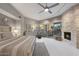 Bright bedroom with fireplace,sliding glass doors to patio, and ensuite bathroom at 10758 E Tamarisk Way, Scottsdale, AZ 85262