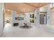 Mid-century modern dining area with round table and chairs, and wood ceiling beams at 10758 E Tamarisk Way, Scottsdale, AZ 85262