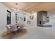 Open concept dining area with a view of the fireplace and living area at 10758 E Tamarisk Way, Scottsdale, AZ 85262