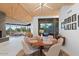 Modern dining room with round table and chairs near a large window at 10758 E Tamarisk Way, Scottsdale, AZ 85262