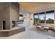 Modern fireplace with unique tile design, built-in shelving, and wood storage at 10758 E Tamarisk Way, Scottsdale, AZ 85262