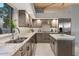 Modern kitchen with gray cabinets, granite countertops, and island at 10758 E Tamarisk Way, Scottsdale, AZ 85262