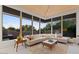 Living room with large windows, sectional sofa, coffee table, and scenic views at 10758 E Tamarisk Way, Scottsdale, AZ 85262